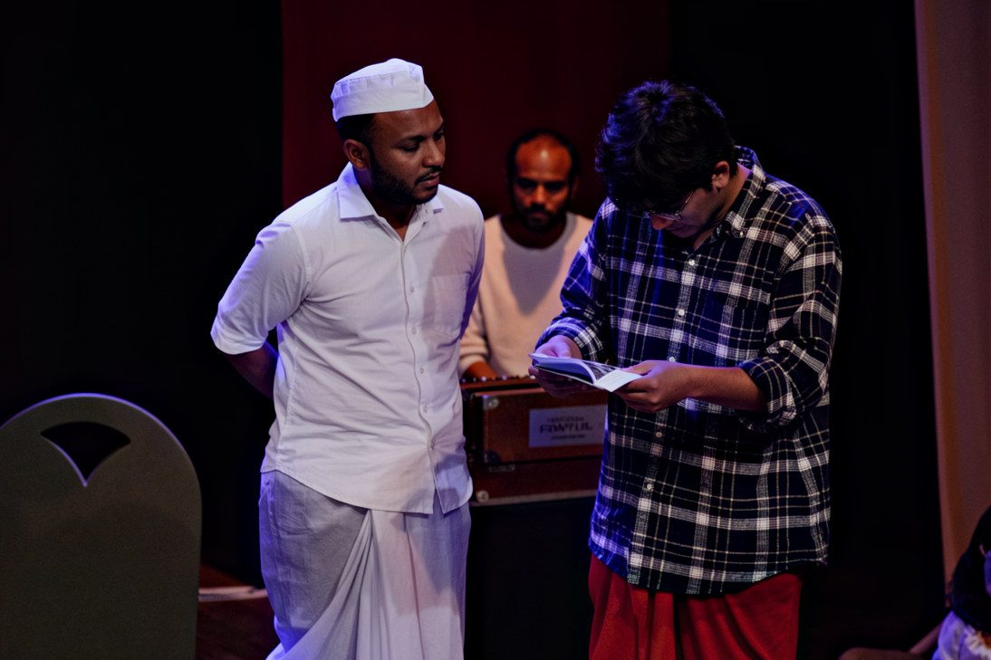 Acting instructor guiding a student through a script during rehearsal.