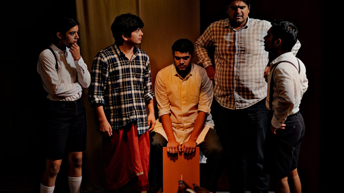 Actors collaboratively creating a devised theatre performance without starting from a finished script.